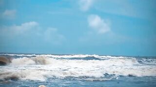 Tik Tok. Beach Voyeur looks on Blonde Teen Enjoying Topless in the Waves.