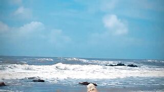 Tik Tok. Beach Voyeur looks on Blonde Teen Enjoying Topless in the Waves.