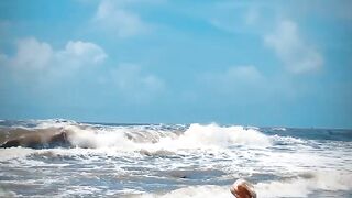 Tik Tok. Beach Voyeur looks on Blonde Teen Enjoying Topless in the Waves.