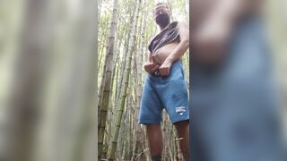 man alone in the woods peeing and relaxing