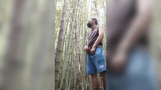 man alone in the woods peeing and relaxing