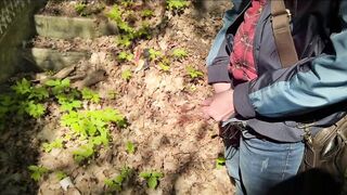 Bearded guy pissing in the forest. A man relieves himself in nature