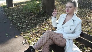 smoking cigarette in the park - flashing pussy, wearing white leather coat and fishnets and higheels