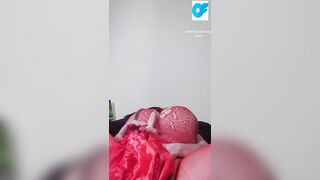 Watch nasty Susi lying on back playing with toy between tits