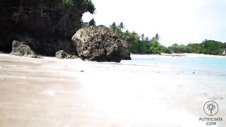 Putri Cinta stripping on a beautiful tropical beach