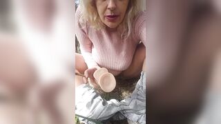 The milf next door jerks off in the countryside