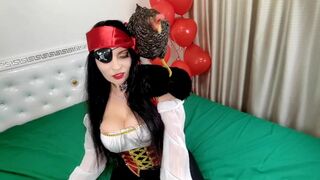 Pretty pirate with a parrot hides treasures in her mouth and jerks off