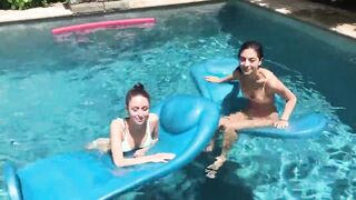 Two Bikini Teens challenging each other in pool